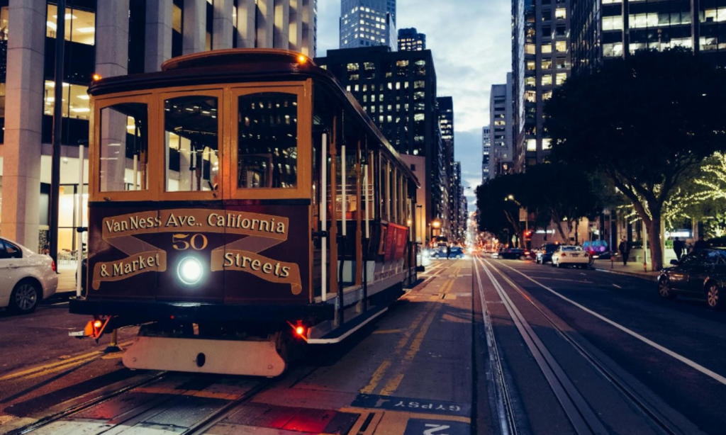 A trolley car on a city street at night