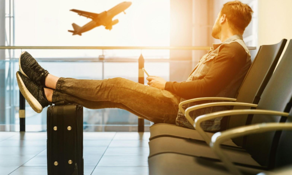 A man sitting in an airport lounge for a plane