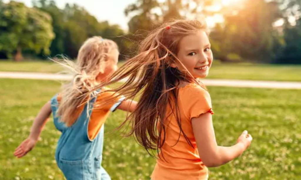 Two young girls joyfully running