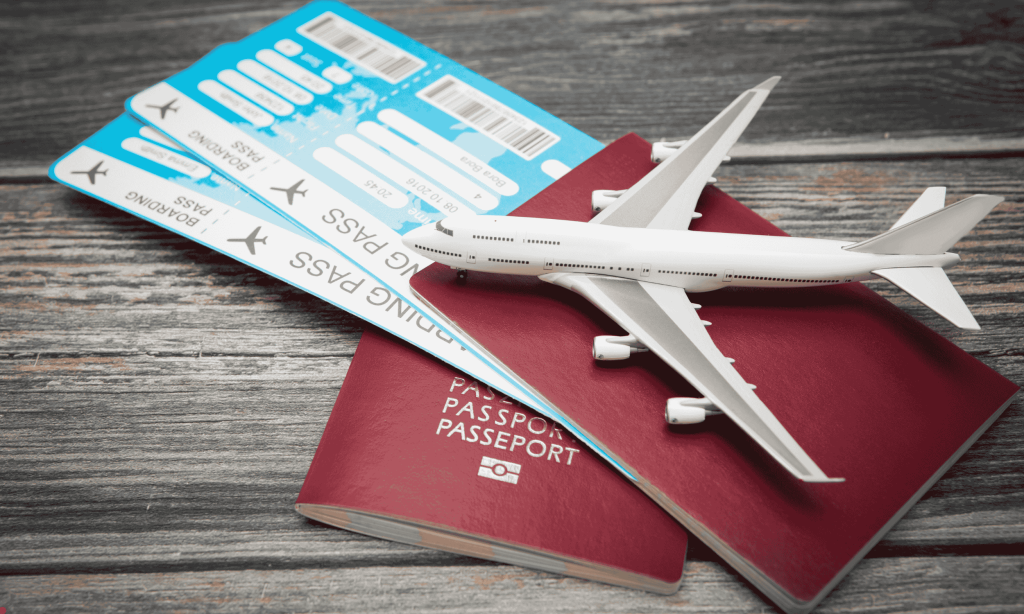 a toy plan on two passports and boarding passes on a wooden surface